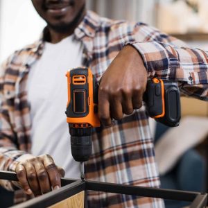 african-american-man-assembling-furniture-at-home